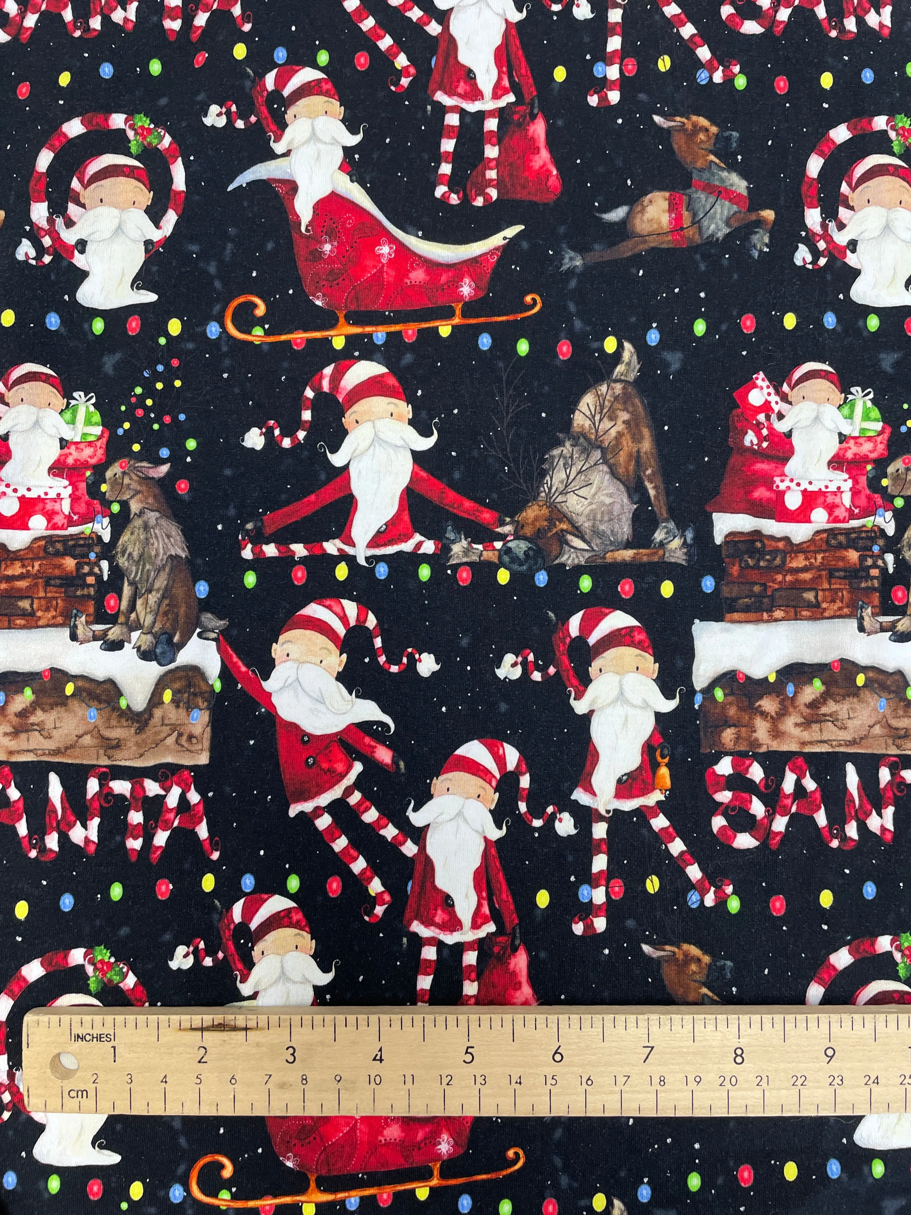 SALE 5/8 YD Cotton/Spandex Remnant - Black with Whimsical Santas & Reindeer